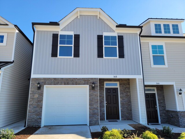 3618 Tarmac Rd Unit Ep 130, Wilson, NC 27896 - view of front of property with stone siding, a garage, concrete driveway, and board and batten siding