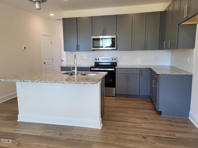 3618 Tarmac Rd Unit Ep 130, Wilson, NC 27896 - kitchen with appliances with stainless steel finishes, a sink, light stone countertops, recessed lighting, and dark wood-type flooring