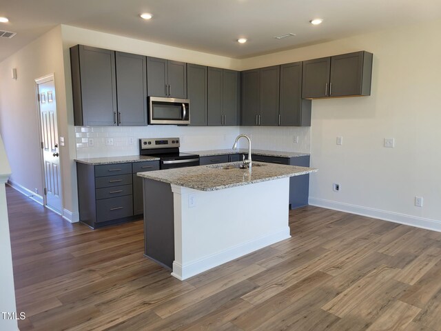 3618 Tarmac Rd Unit Ep 130, Wilson, NC 27896 - kitchen featuring appliances with stainless steel finishes, a sink, decorative backsplash, dark wood-style flooring, and recessed lighting