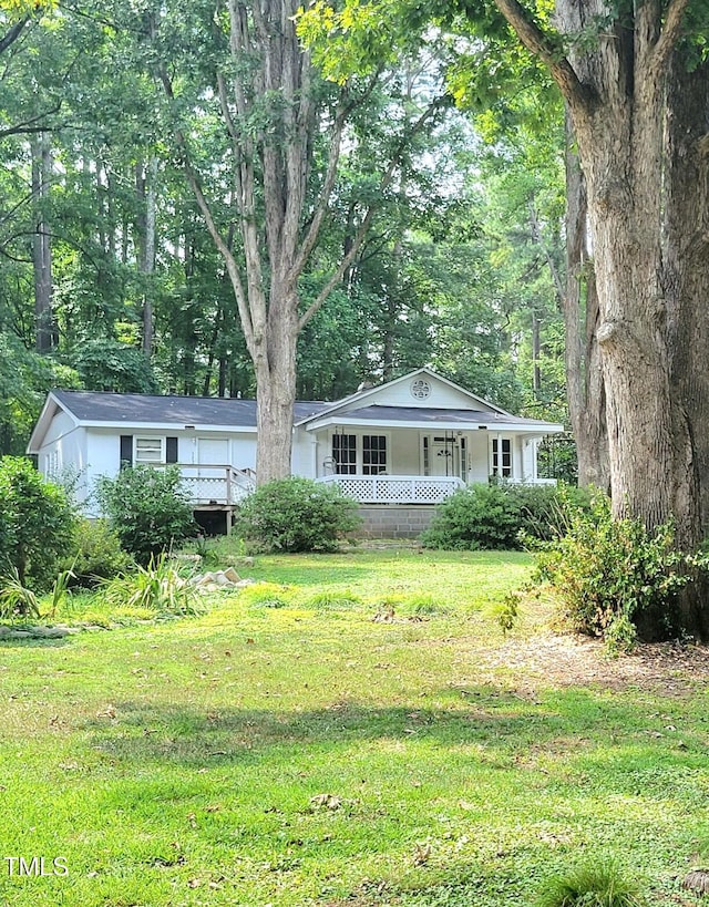 ranch-style home featuring a front yard and covered porch