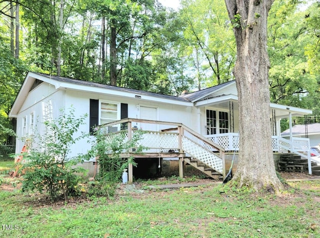 rear view of house featuring a wooden deck