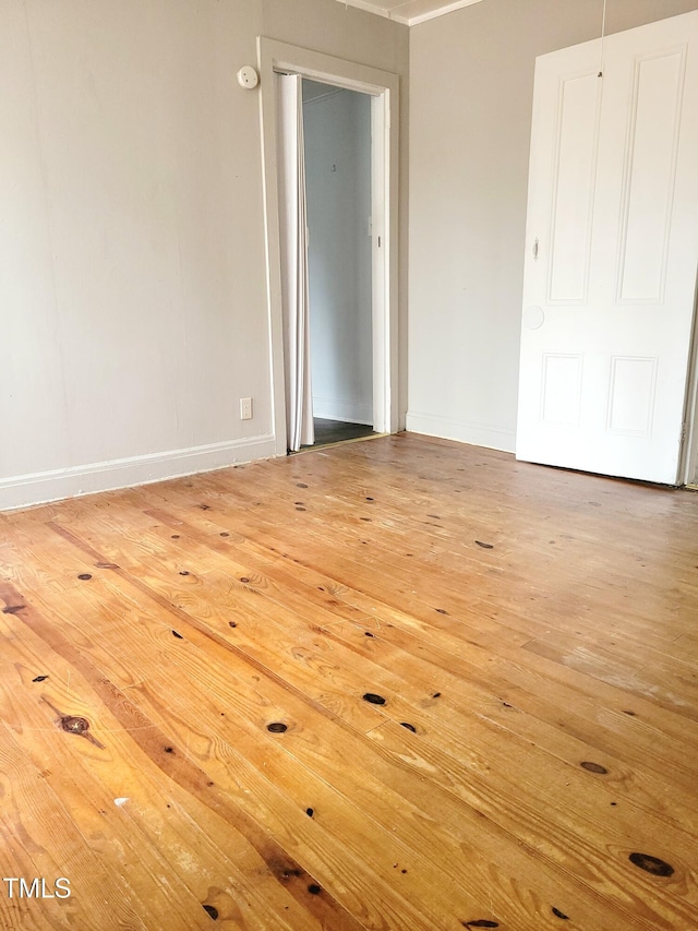 spare room featuring wood-type flooring