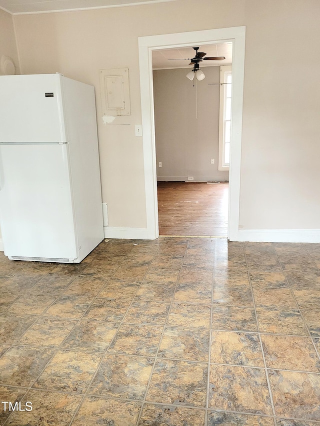 interior space with ceiling fan, white fridge, and wood-type flooring