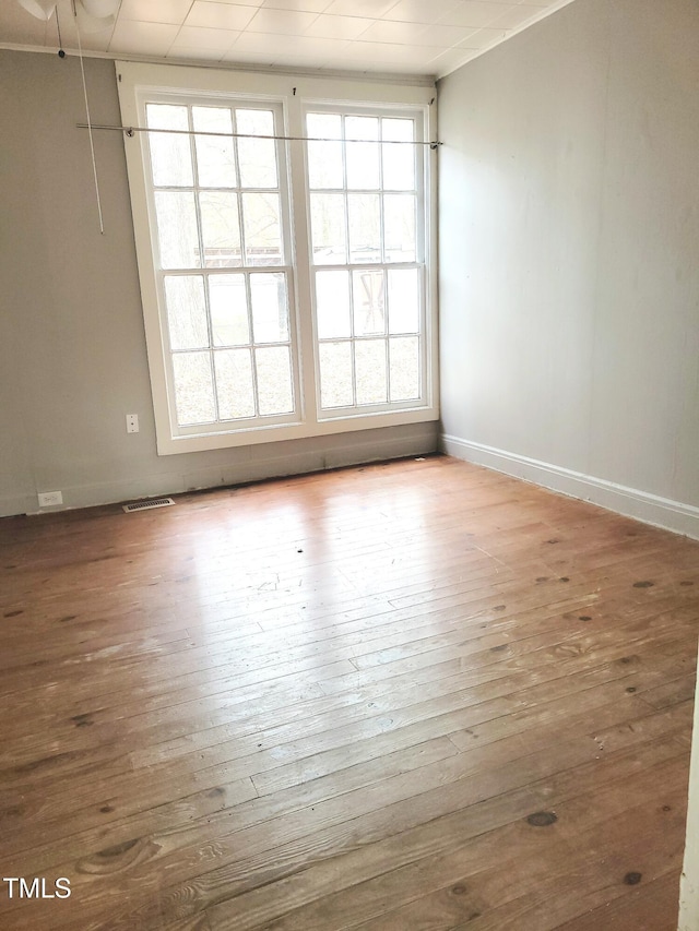 spare room featuring wood-type flooring