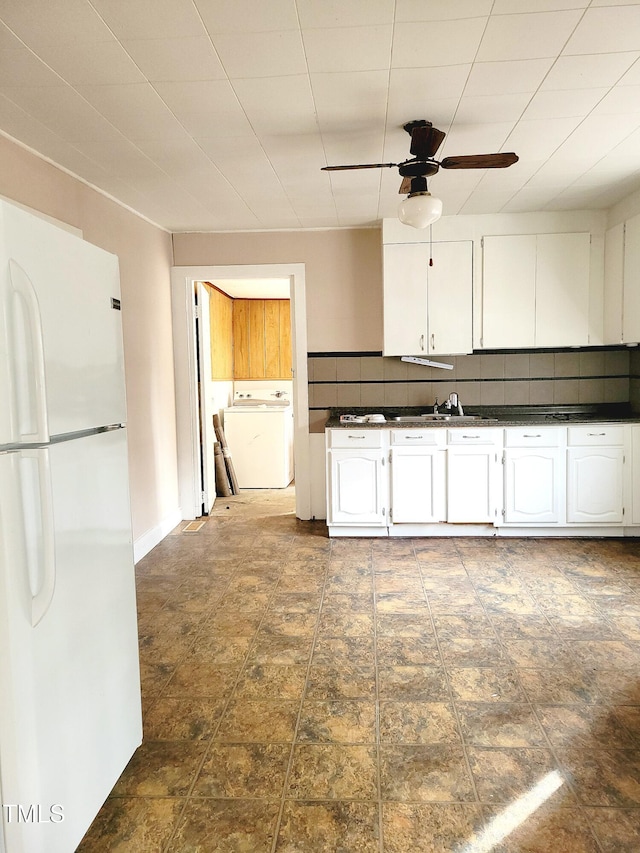 kitchen with white cabinetry, ceiling fan, backsplash, washer / clothes dryer, and white fridge