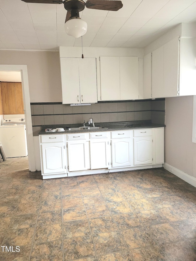 kitchen featuring white cabinets, sink, tasteful backsplash, ceiling fan, and washer / dryer