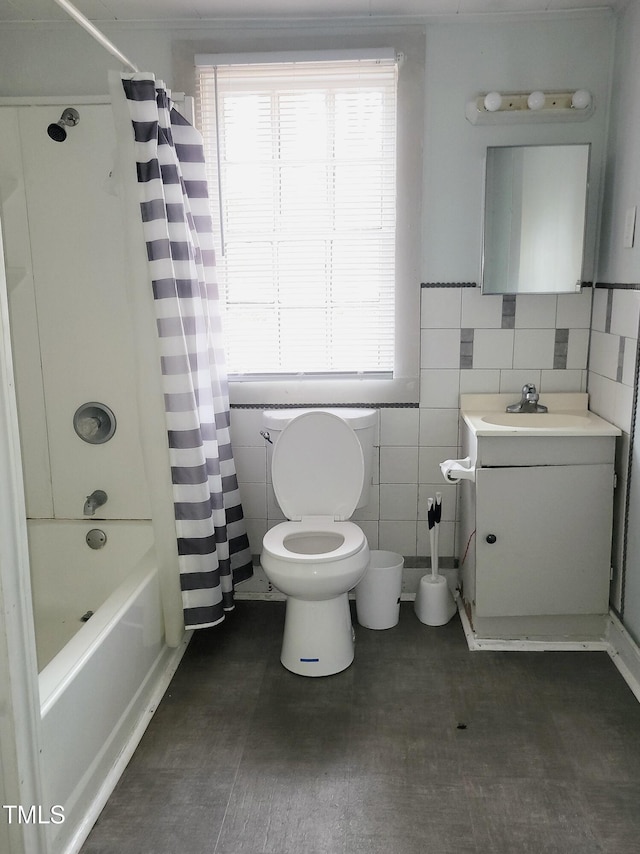 full bathroom with toilet, vanity, tile walls, and shower / bathtub combination with curtain