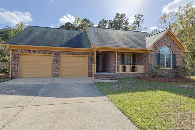 ranch-style home featuring a garage, a front lawn, and a porch