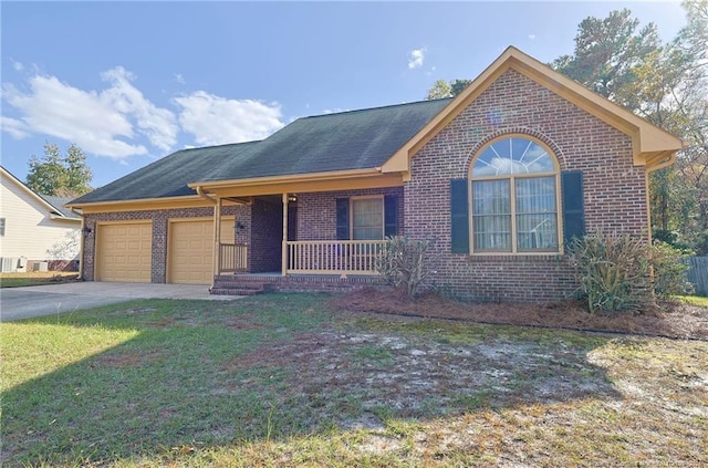 ranch-style home featuring a front yard, covered porch, and a garage