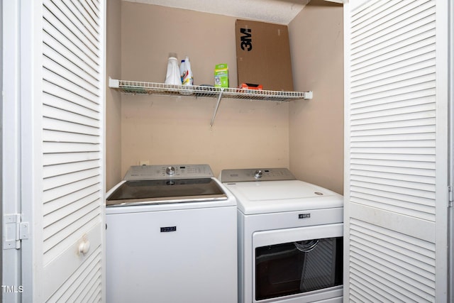 laundry area with separate washer and dryer