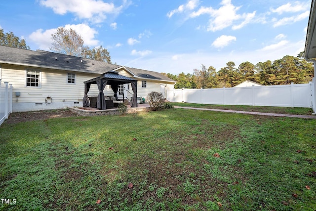 back of property featuring a gazebo, a yard, and a patio area