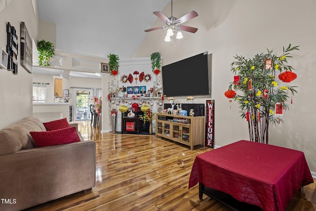 living room with high vaulted ceiling, wood-type flooring, and ceiling fan