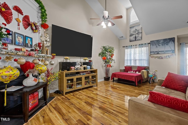 living room featuring hardwood / wood-style flooring, high vaulted ceiling, and ceiling fan