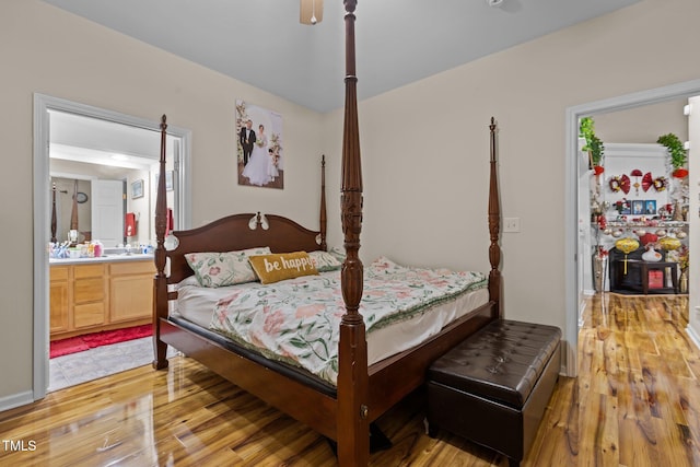 bedroom featuring connected bathroom, light hardwood / wood-style floors, and ceiling fan