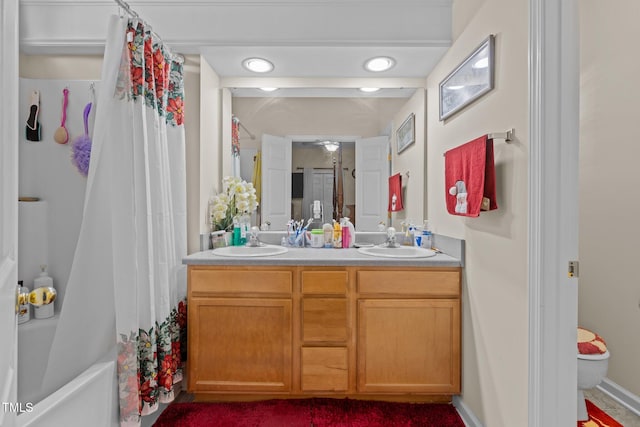 full bathroom featuring vanity, shower / tub combo, and toilet