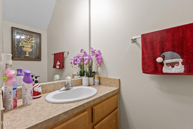 bathroom featuring vanity and vaulted ceiling