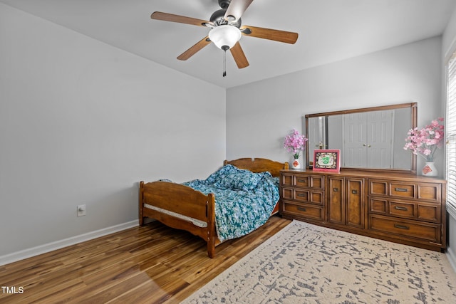 bedroom with ceiling fan and wood-type flooring