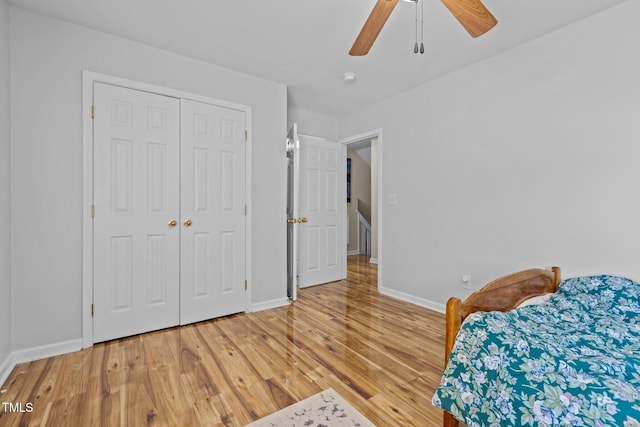 unfurnished bedroom with light hardwood / wood-style flooring, a closet, and ceiling fan