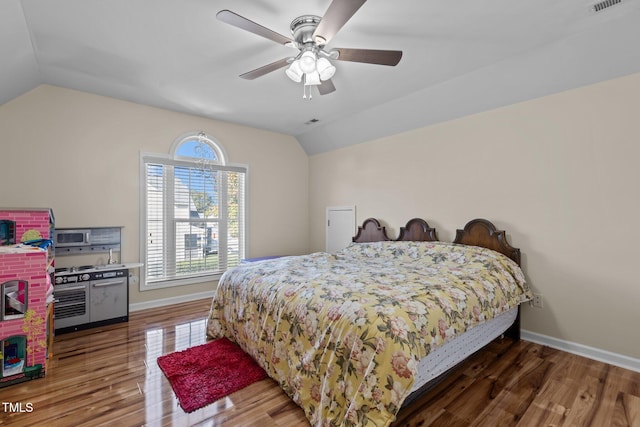 bedroom with ceiling fan, lofted ceiling, and dark hardwood / wood-style flooring