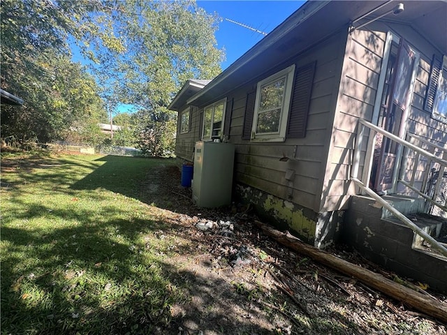 view of side of home with a lawn