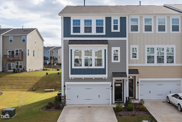 view of front of home with a front lawn and a garage