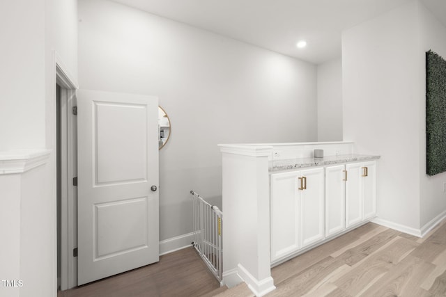 interior space with vanity and hardwood / wood-style floors