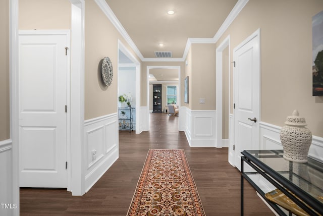 corridor featuring ornamental molding and dark hardwood / wood-style flooring