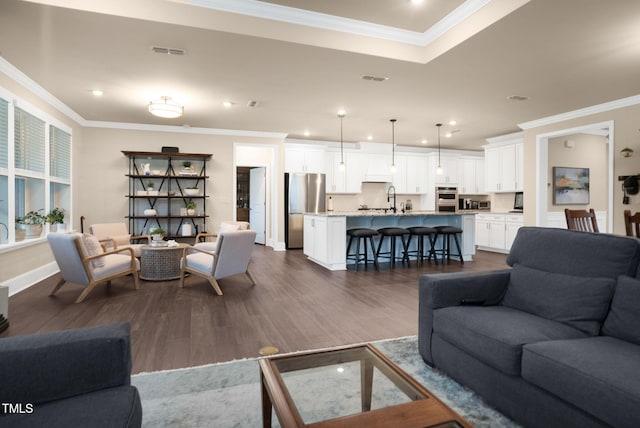 living room featuring sink, dark wood-type flooring, and crown molding