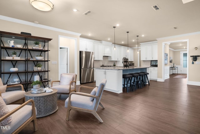 living room with ornamental molding, sink, and dark hardwood / wood-style flooring