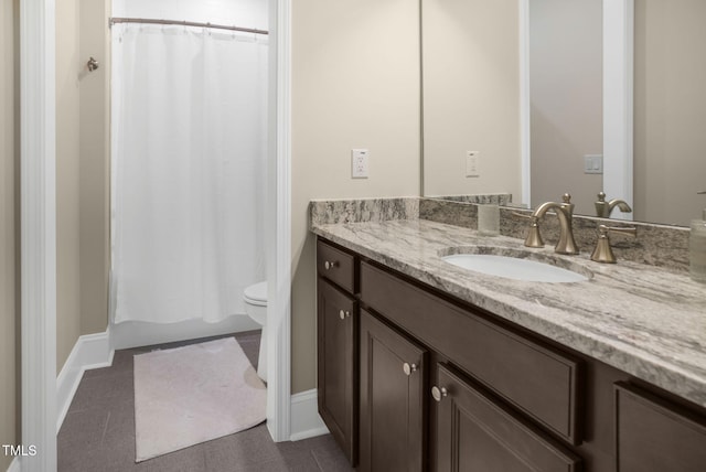 bathroom with vanity, toilet, and tile patterned floors