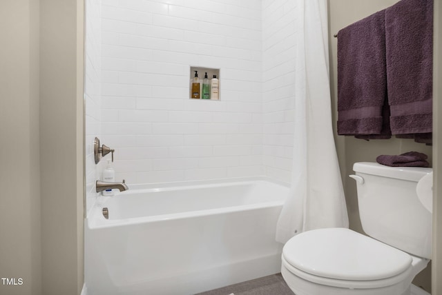 bathroom with shower / bath combo and toilet