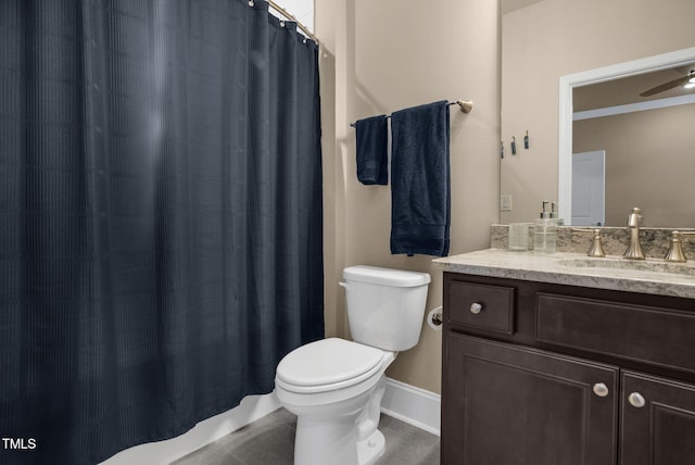 bathroom featuring walk in shower, vanity, toilet, and ceiling fan