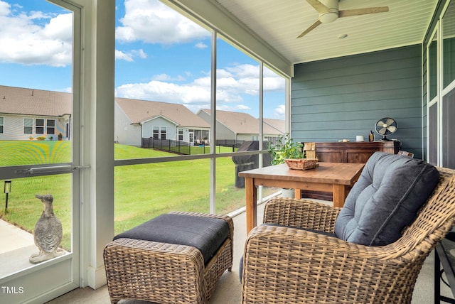 sunroom featuring ceiling fan