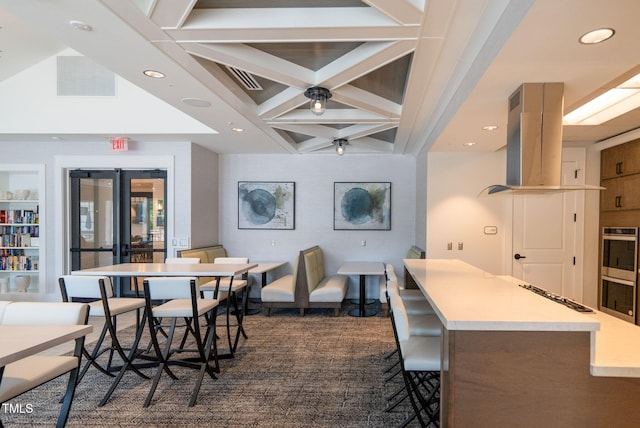 dining area featuring french doors, coffered ceiling, and beamed ceiling