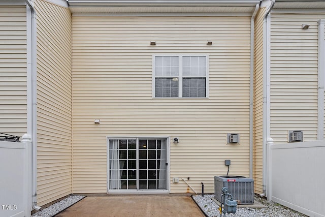 rear view of property featuring a patio and central air condition unit