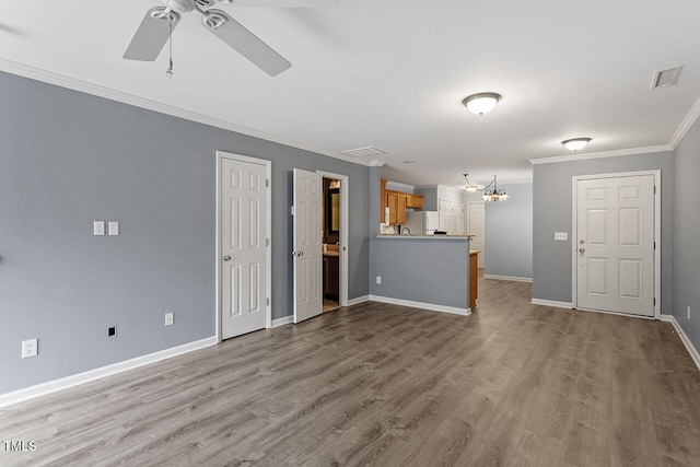 unfurnished living room featuring light wood-type flooring, ceiling fan with notable chandelier, and crown molding