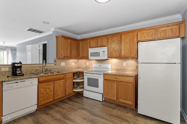 kitchen with sink, light stone countertops, white appliances, crown molding, and dark hardwood / wood-style flooring