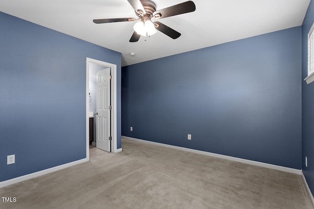 spare room with light carpet and ceiling fan