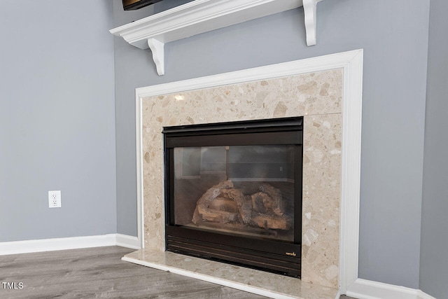 room details featuring hardwood / wood-style floors and a high end fireplace