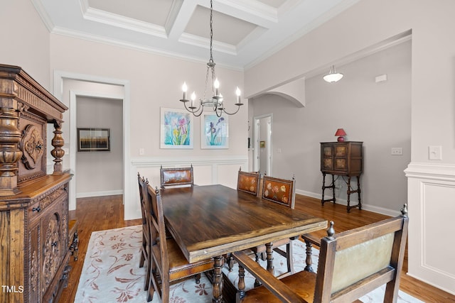 dining area with beamed ceiling, coffered ceiling, crown molding, and hardwood / wood-style flooring