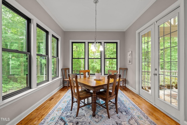 dining space with ornamental molding, light hardwood / wood-style floors, and plenty of natural light