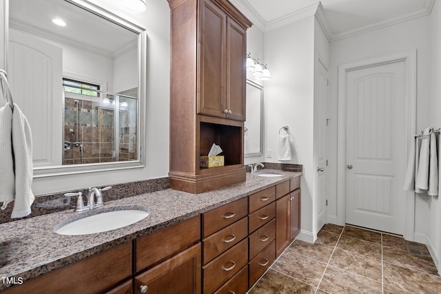 bathroom with a shower with door, vanity, and crown molding