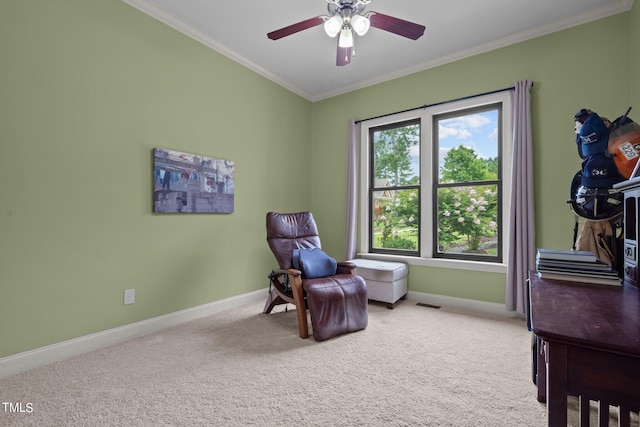 sitting room with ornamental molding, carpet flooring, and ceiling fan