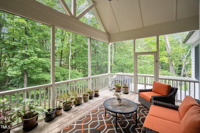 unfurnished sunroom with plenty of natural light and vaulted ceiling