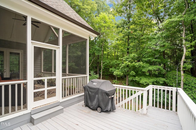 wooden deck featuring area for grilling and a sunroom