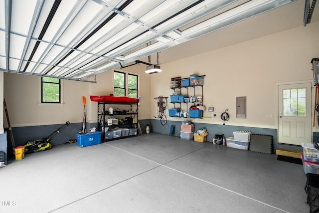 garage with a garage door opener and electric panel