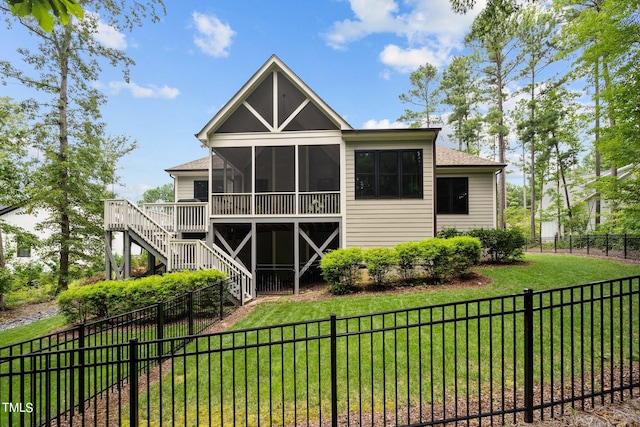 rear view of house with a wooden deck, a yard, and a sunroom