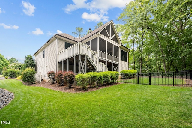 back of property featuring a lawn and a sunroom