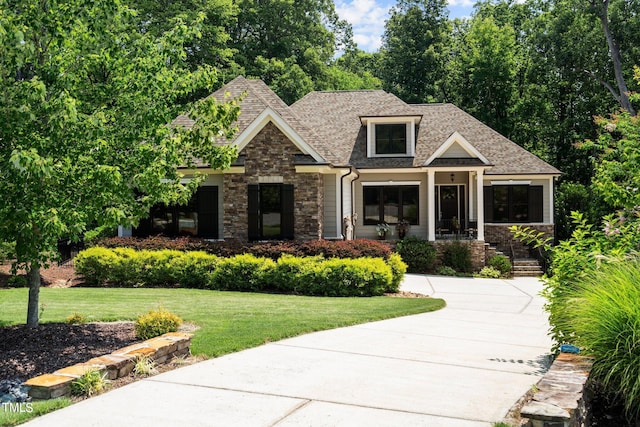 craftsman-style home featuring a front yard and covered porch