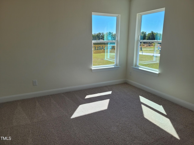 spare room with carpet and baseboards
